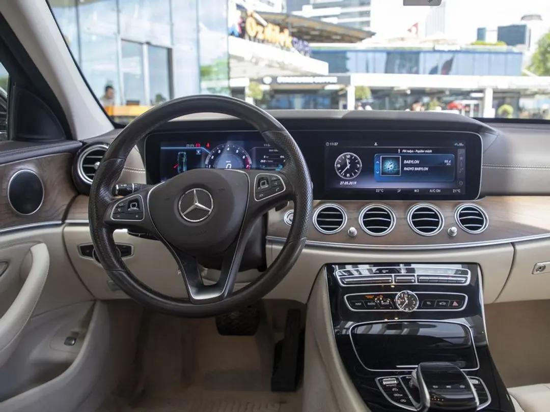 Mercedes-Benz E-Class cockpit with digital displays and beige leather