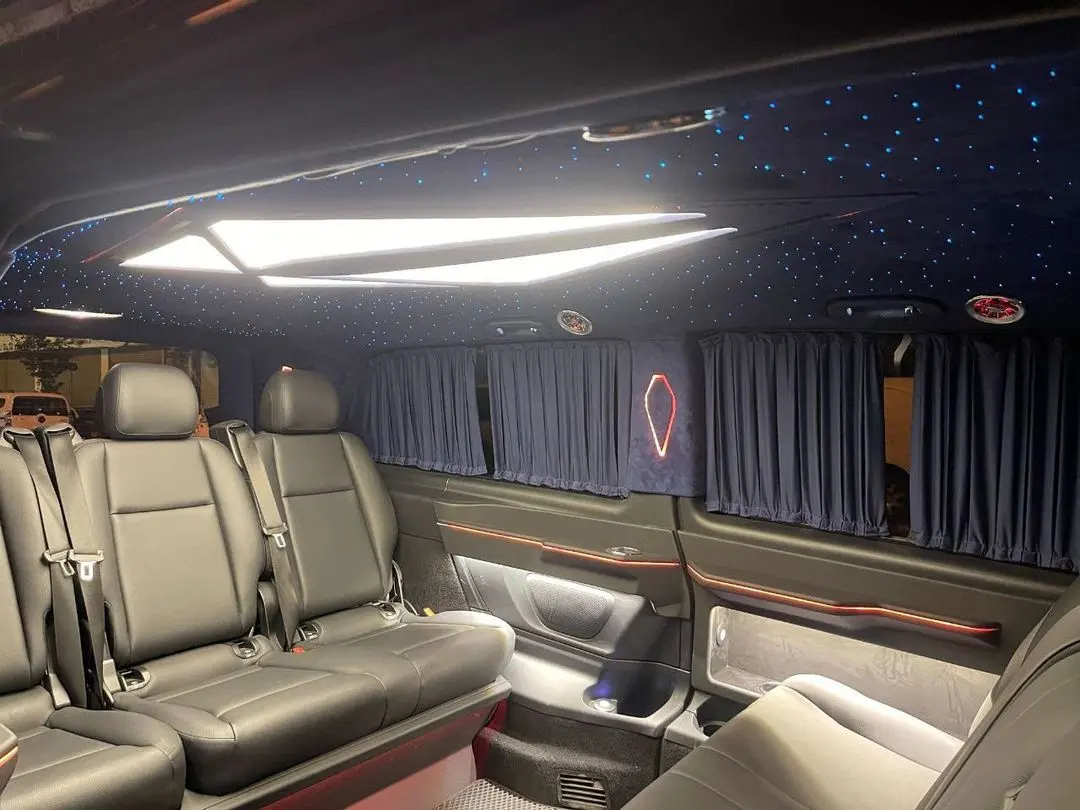 VIP van cabin with a lit ceiling panel, starlight roof and privacy curtains