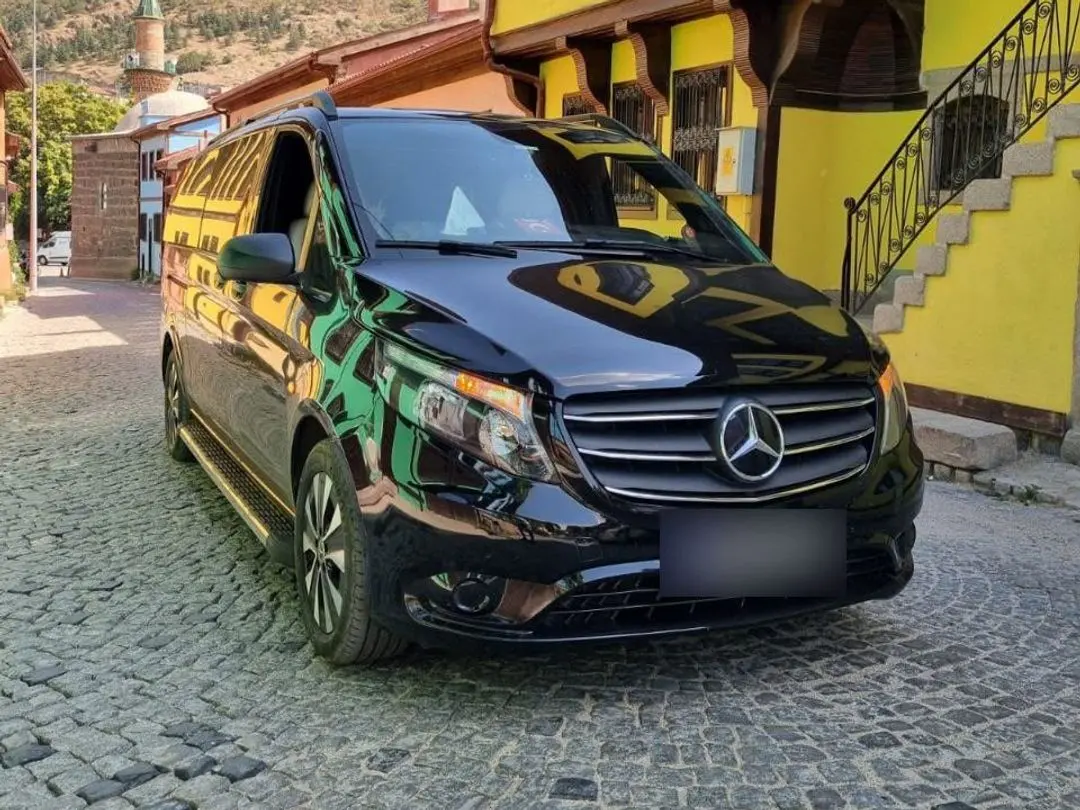 Black VIP-converted Mercedes van in front of a historic Ottoman house