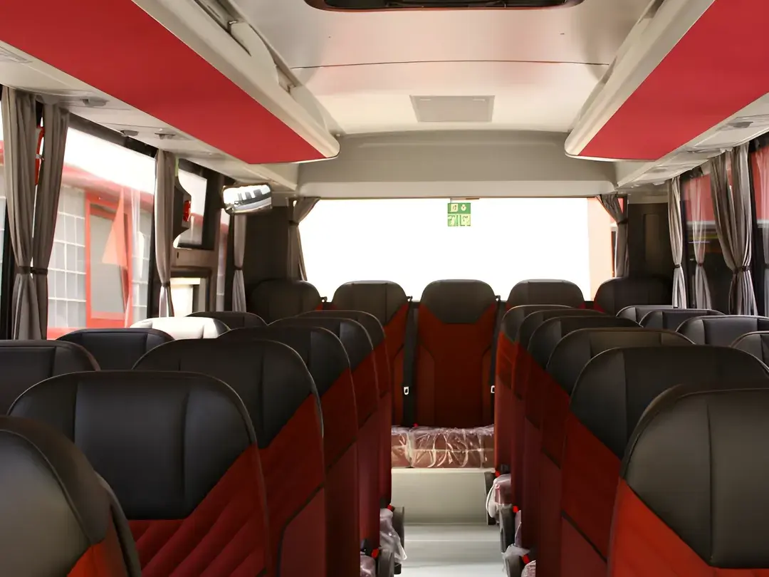 Midibus interior with red and black seats and curtains