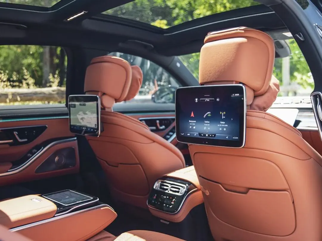 Mercedes-Benz S-Class W223 rear cabin with tan leather seats, screens and panoramic roof