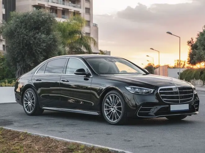 Black Mercedes-Benz S-Class W223 sedan at sunset
