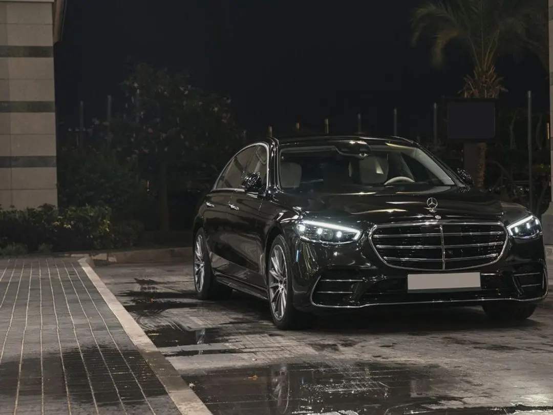 Black Mercedes-Benz S-Class W223 sedan at night, front view