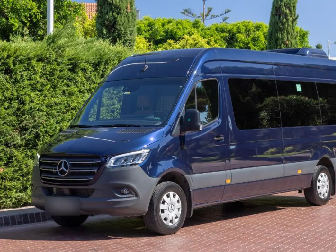 Dark blue Mercedes Sprinter VIP minibus, front three-quarter view