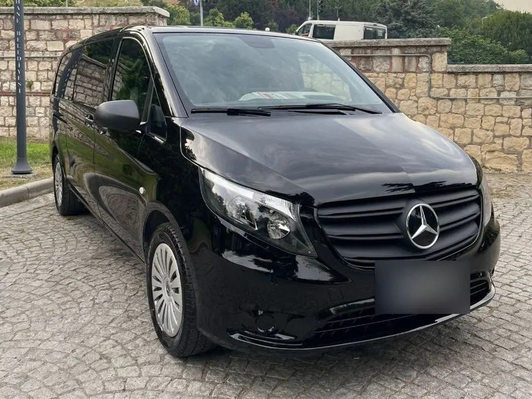 Black Mercedes Vito minivan parked on a cobbled street