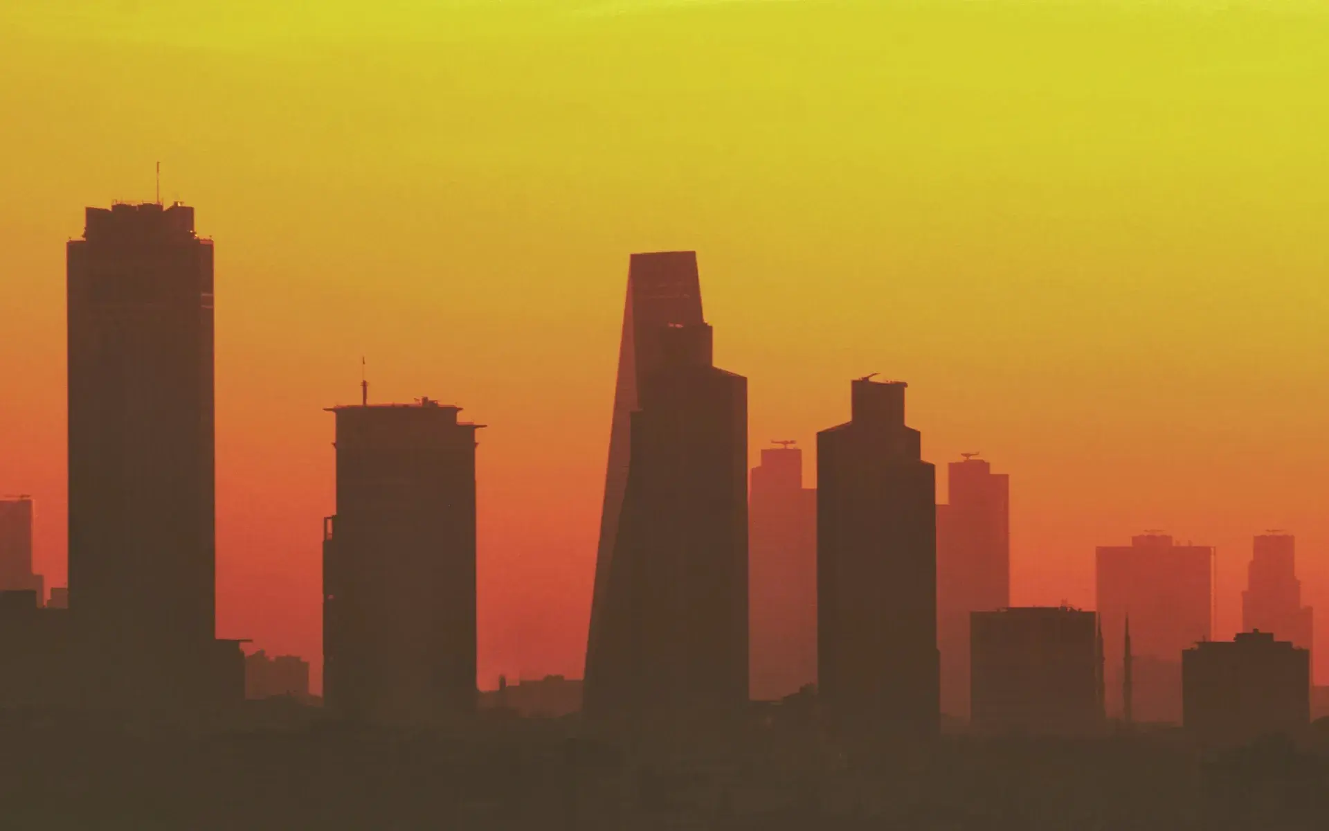 The skyscrapers of Levent in silhouette against an orange sunset