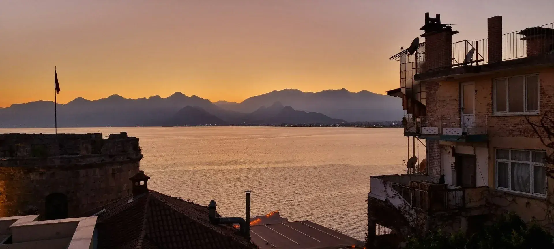 Sunset over the Antalya bay with the Taurus mountains behind