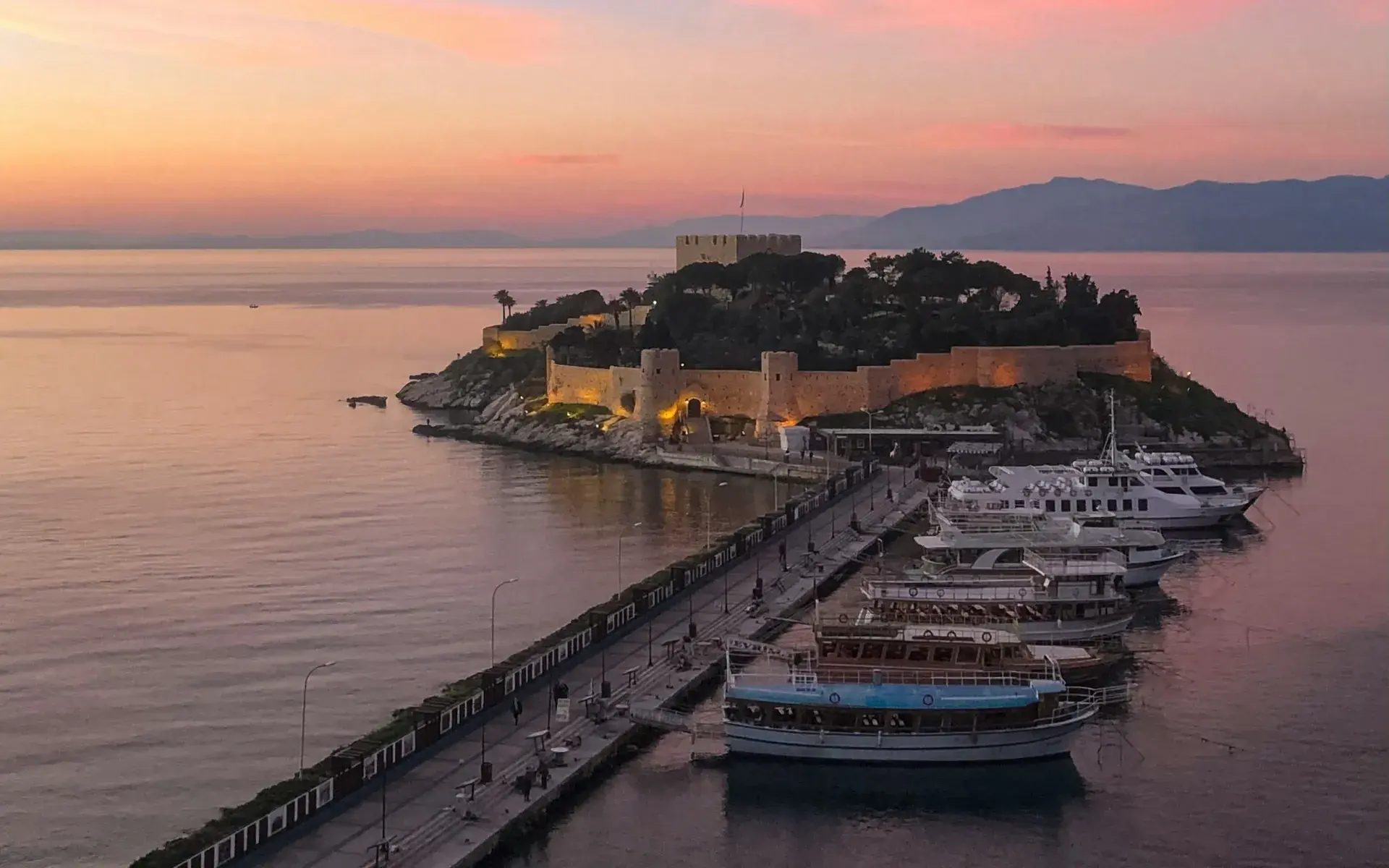 Pigeon Island and its castle at Kuşadası harbour at sunset