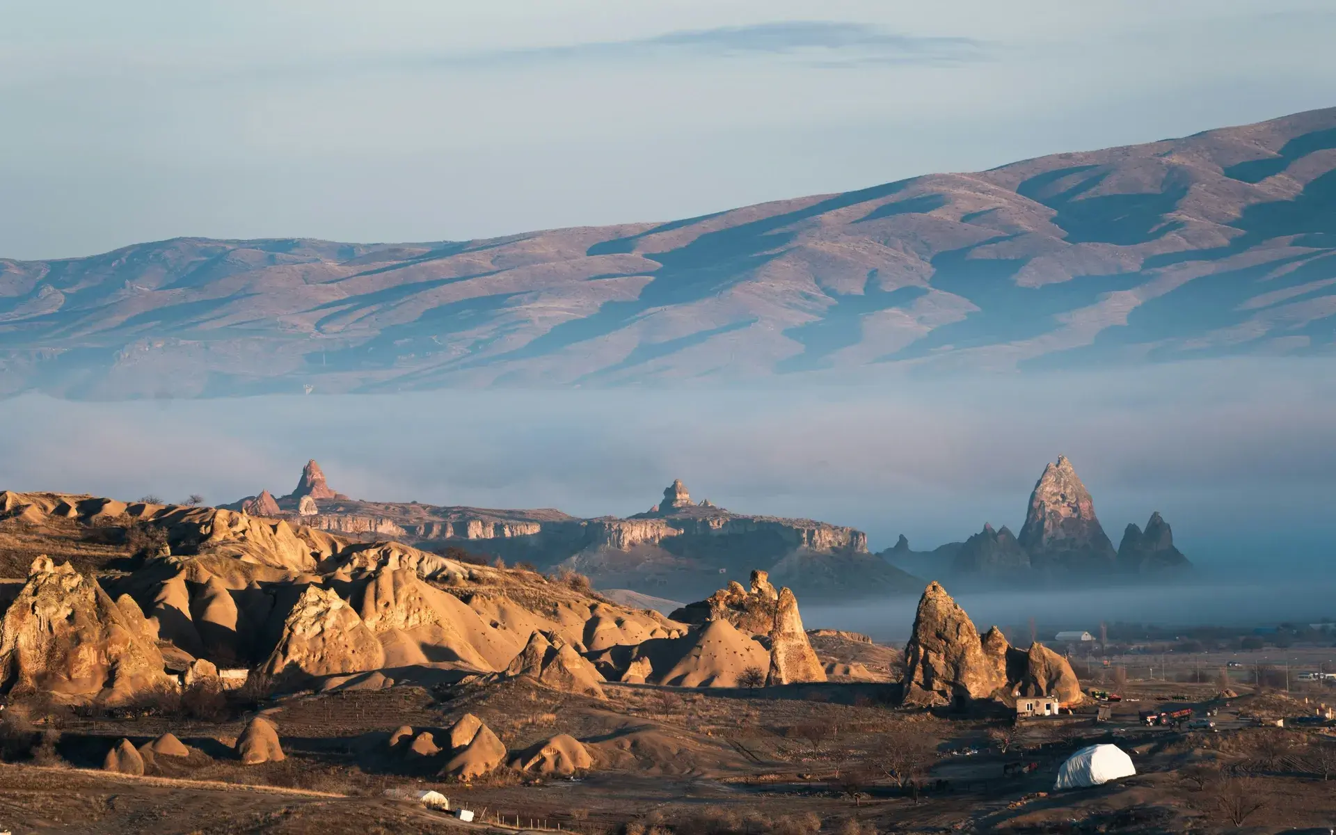 Fairy chimneys near Göreme rising above a layer of morning fog