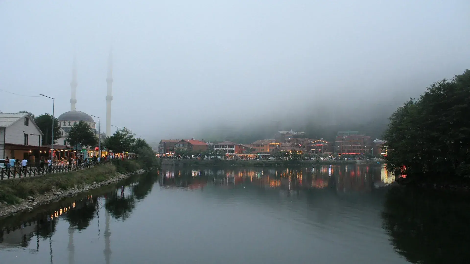 Mist over Uzungöl with the lakeside mosque reflected in the water
