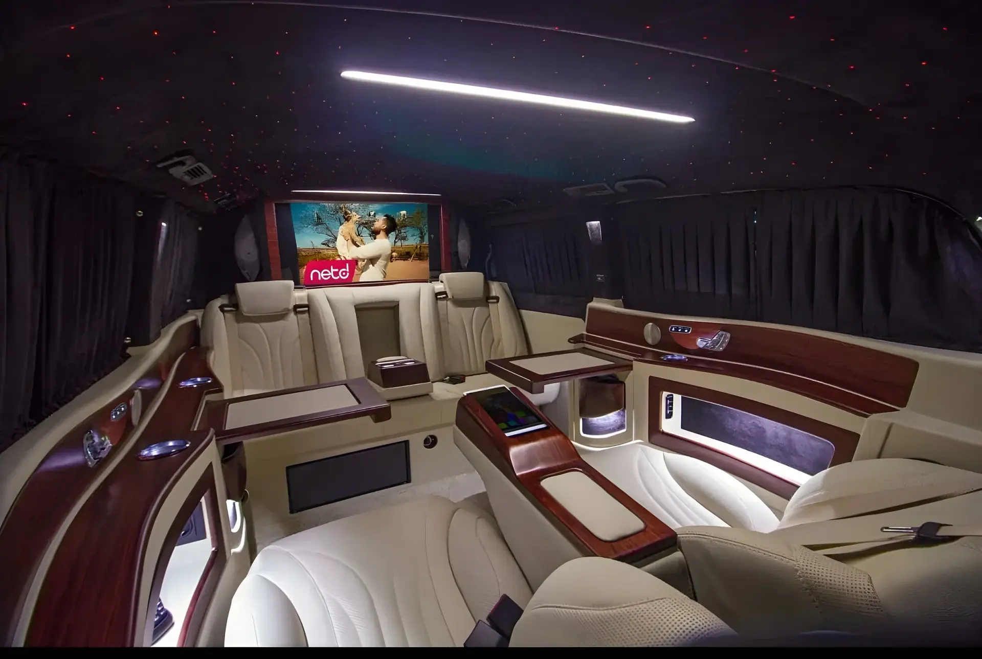 Mercedes V-Class VIP interior — cream leather seats, wood tables and starlight ceiling