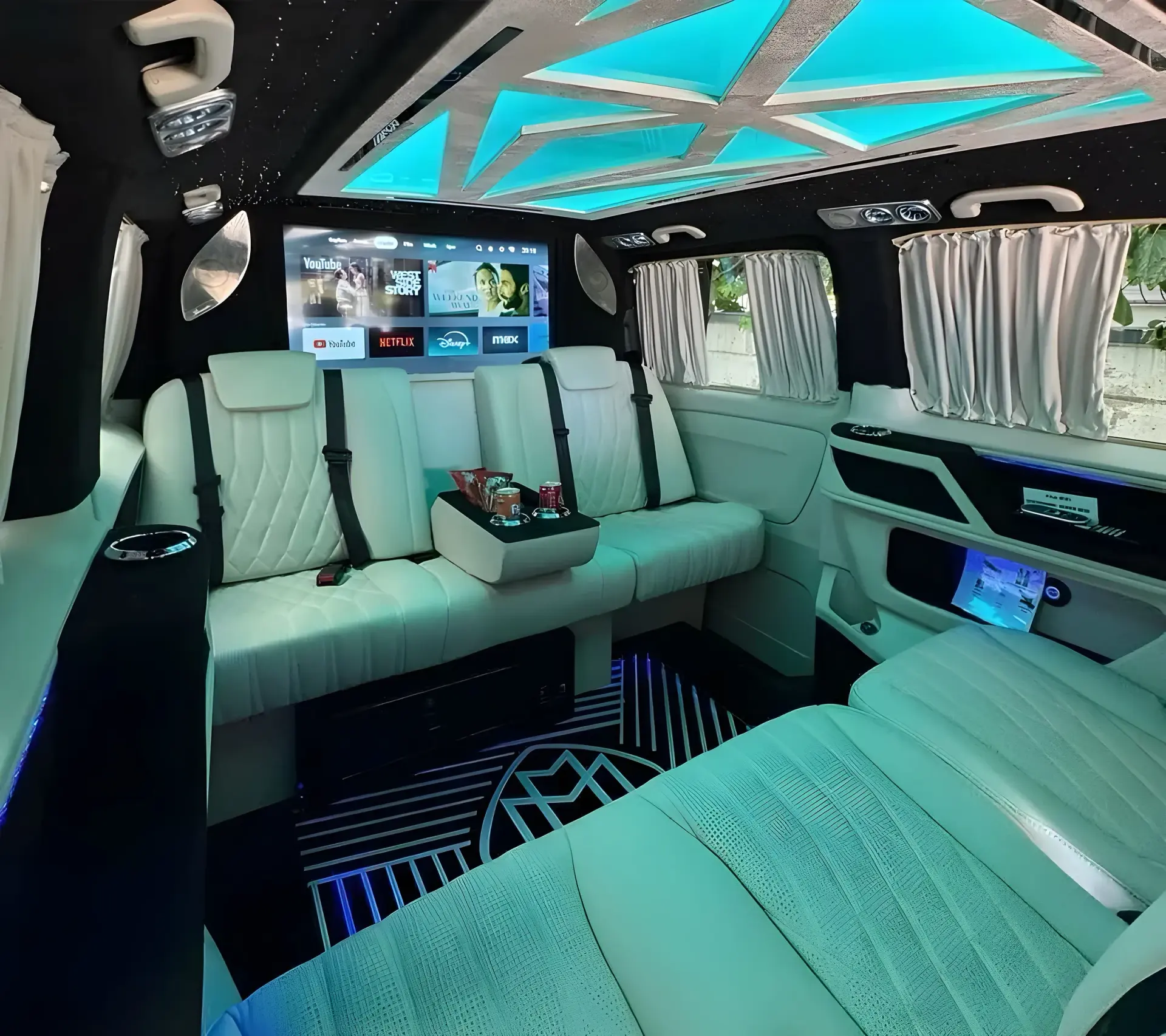 Mercedes V-Class VIP cabin with white quilted leather seats and ambient ceiling lights